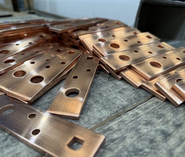 CNC machined copper busbars with drilled holes and slots